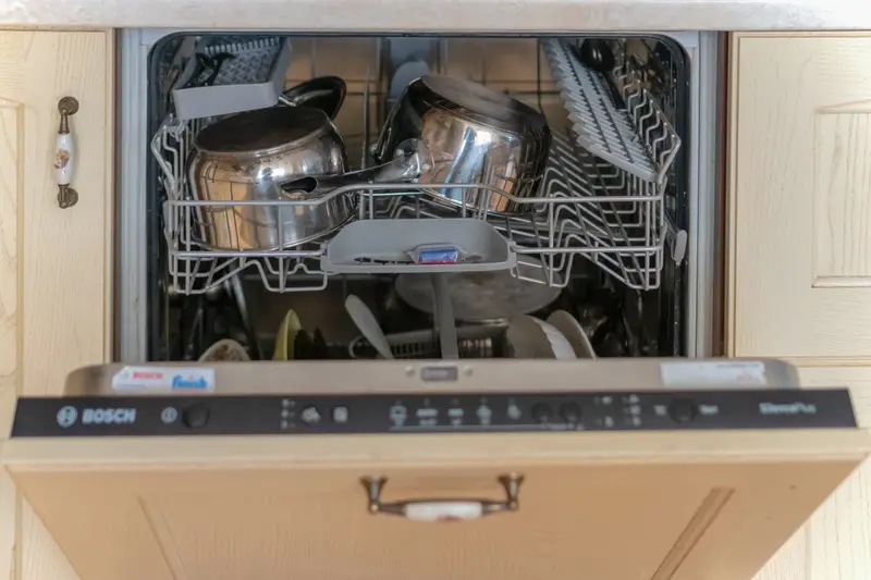 Open dishwasher with dirty dishes