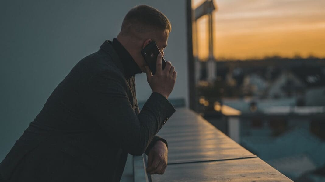 man in black long sleeve shirt sitting by the table | Photo by René Ranisch on Unsplash