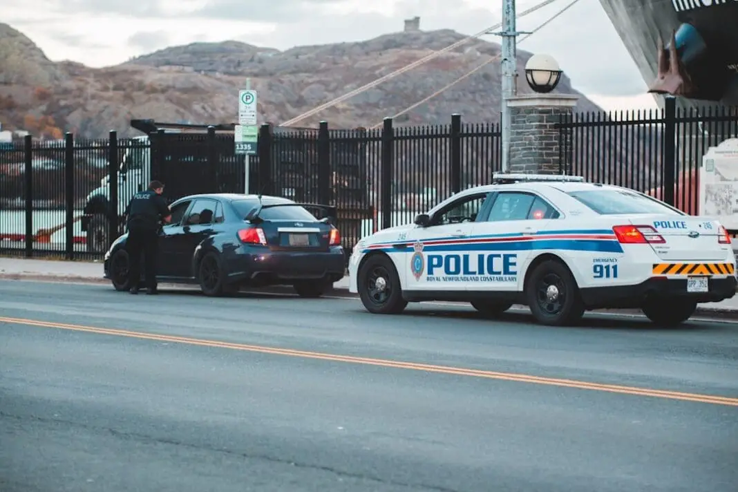 blue and white police car on road during daytime