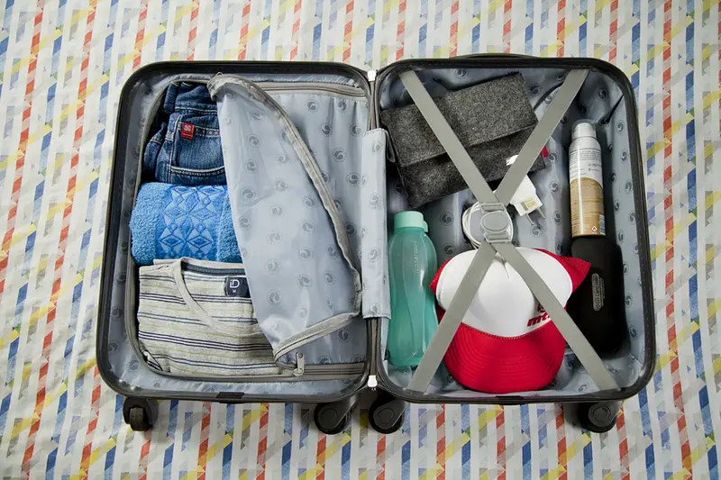 SÃƒO PAULO, BRASIL - November 06, 2017: Suitcase ready for vacation trip, with several clothes and accessories