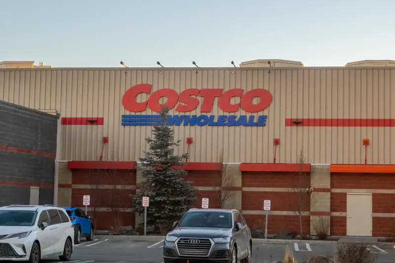 The exterior facade of a Costco Wholesale warehouse building with branded signage