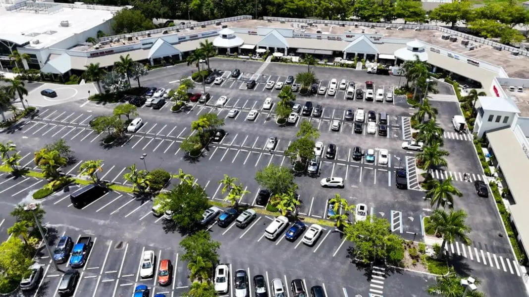 Drone view of a large parking lot at a shopping center in Naples, Florida