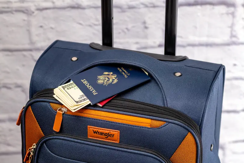 Passport and cash in luggage pocket Wrangler travel bag detail for international travel