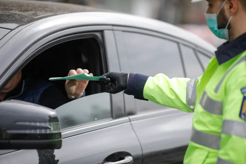 Romanian road police officer pulls over a car to check for the driver’s identity papers