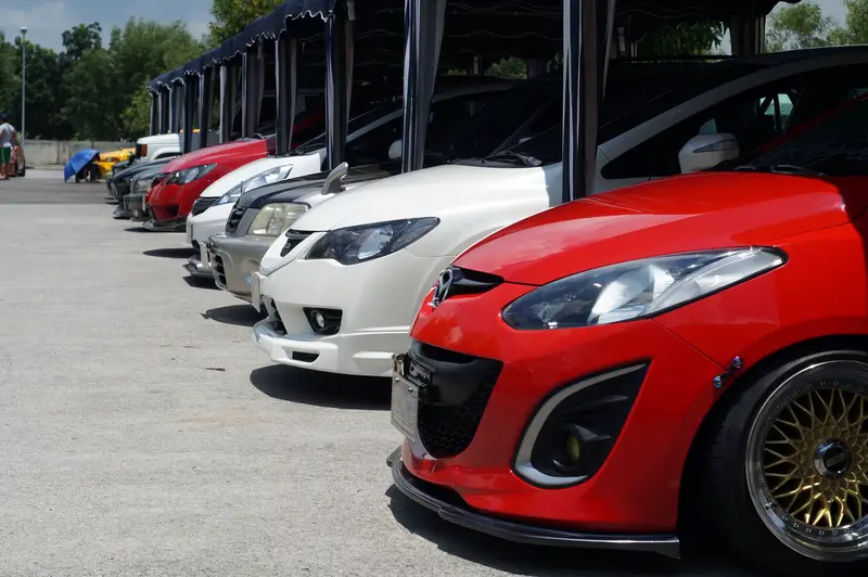 Row Of different Car color and model parked in a car show yard