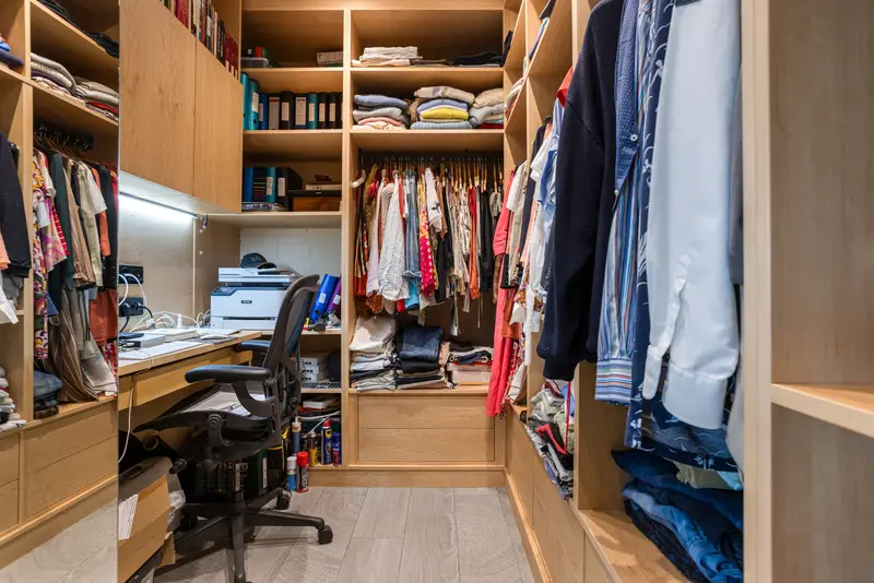 Walk-in closet with built-in workspace and organized clothing shelves