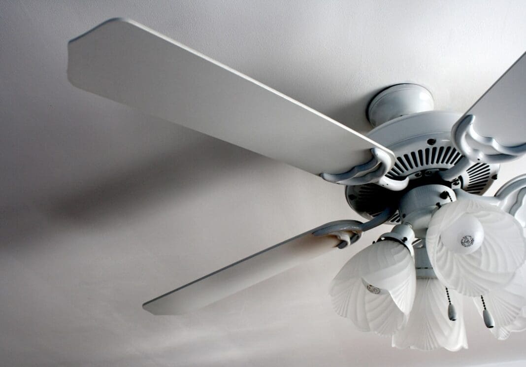 a white ceiling fan in a white room