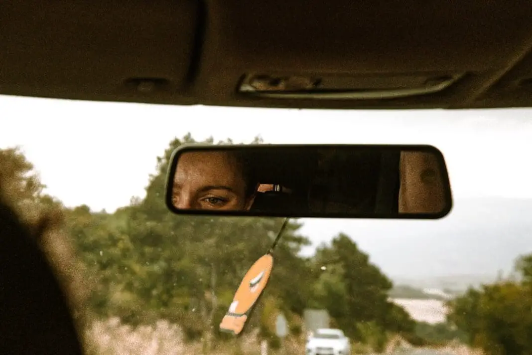 a man is looking out the window of a car