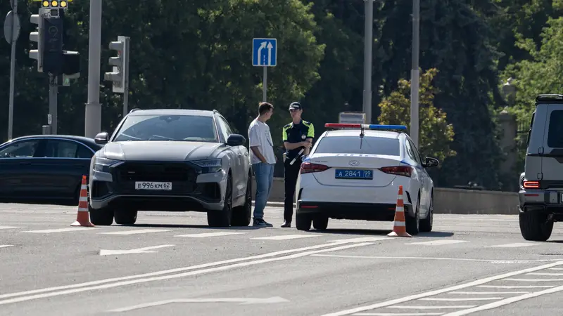 Moscow July 25 2025, A police officer in uniform stands next to a car at