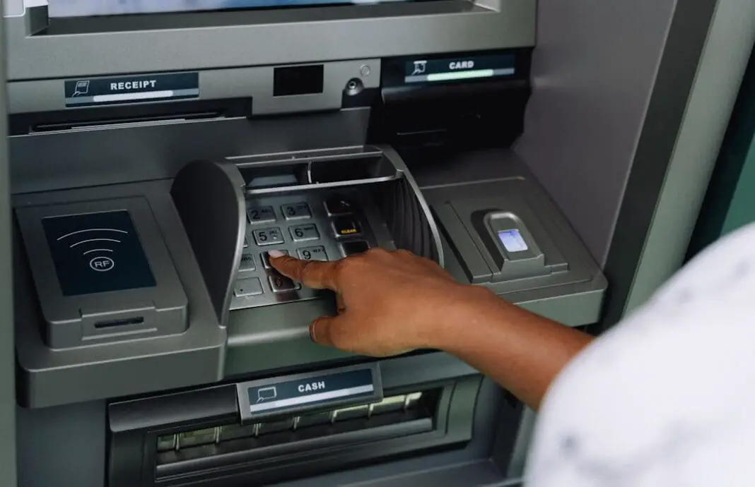African woman using ATM